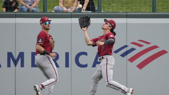 Diamondbacks outfielders Caleb Roberts (left) and Corbin Carroll (7) close off the left center field gap in a Spring Training game against the Chicago White Sox at Camelback Ranch.